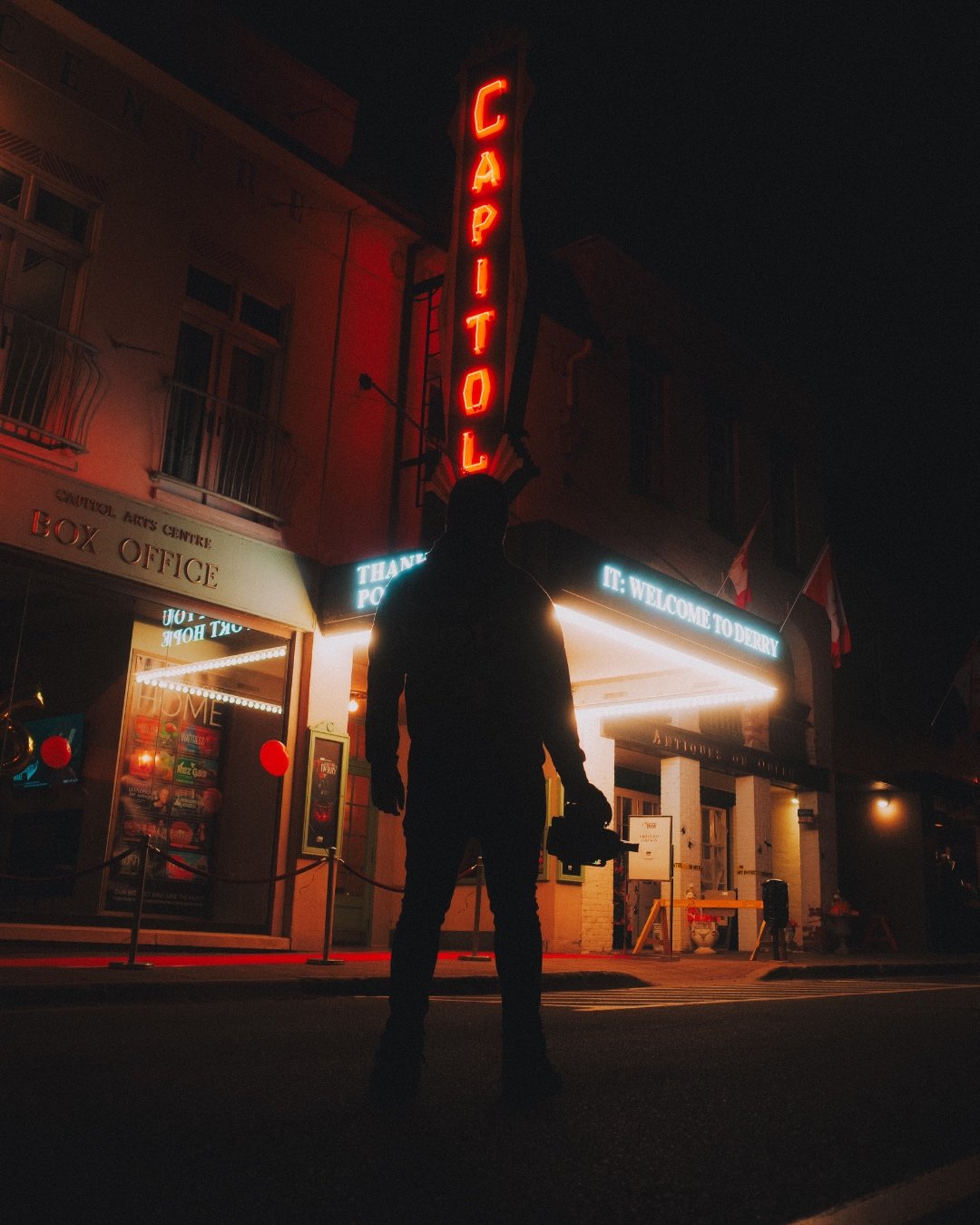 Brett Mourning silhouetted at the Capitol theatre marquee at night