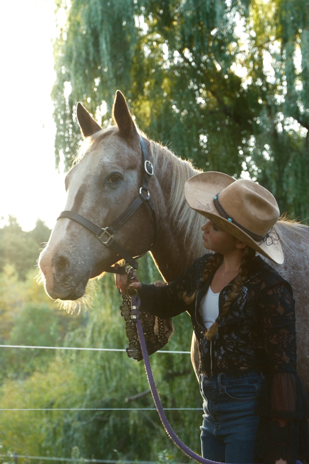 Cowgirl with horse at golden hour