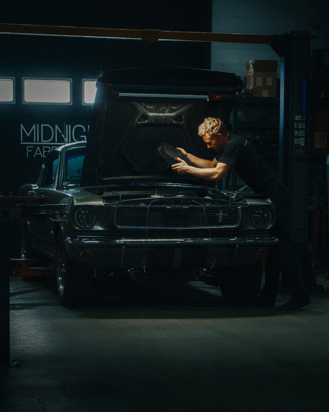 Midnight Fabrication mechanic at work on a Mustang