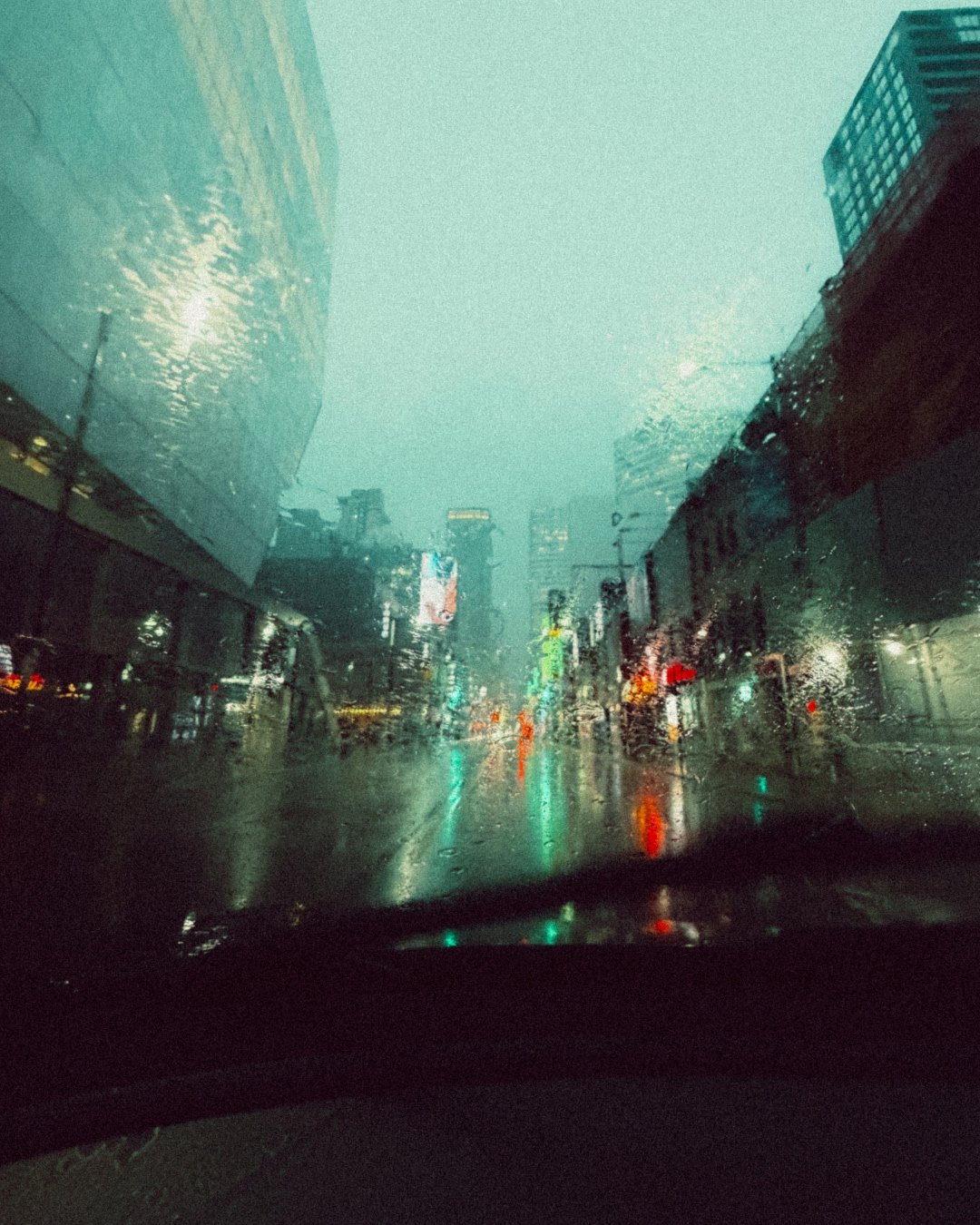 Rainy Toronto night through a windshield